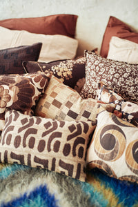 Collection of patterned pillows on a textured surface