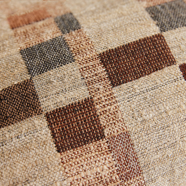 Close-up of a checkered patterned fabric with brown and beige squares.
