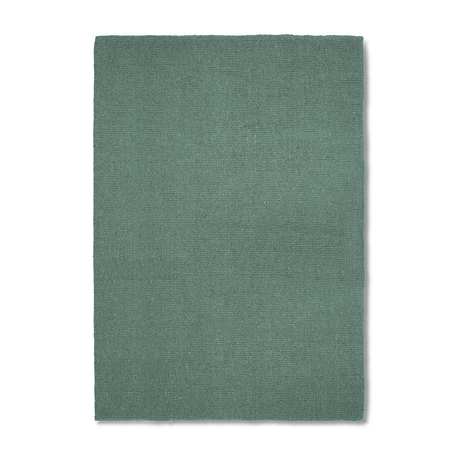 Green rug on a white background