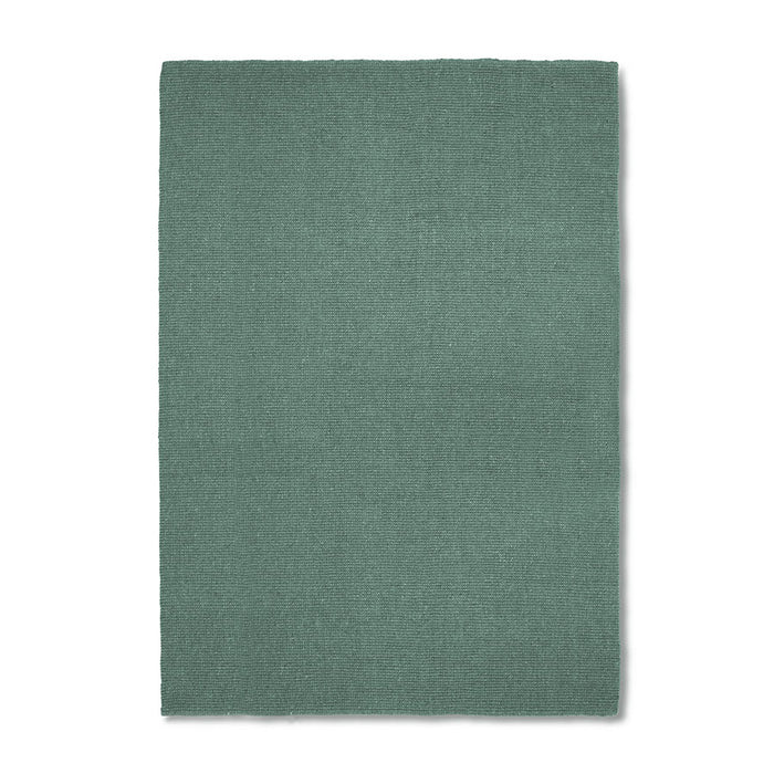 Green rug on a white background