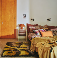 bedroom in retro style with pillows on bed