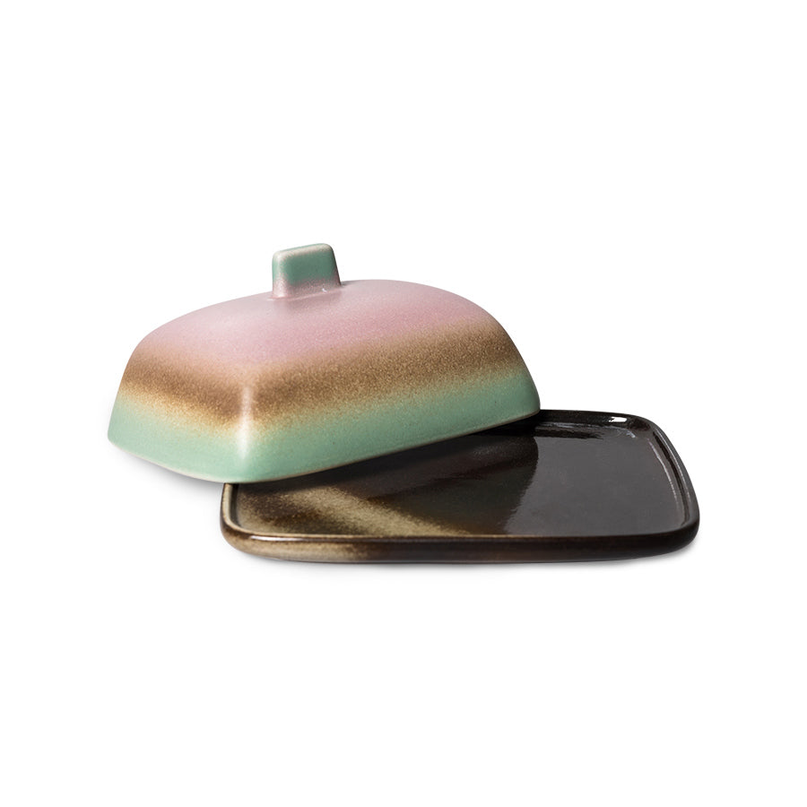 Ceramic butter dish with a lid on a white background