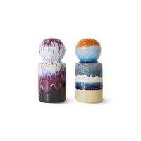 Two ceramic salt and pepper shakers with multicolored glaze on a white background