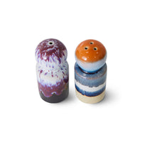 Two ceramic salt and pepper shakers with multicolored glaze on a white background