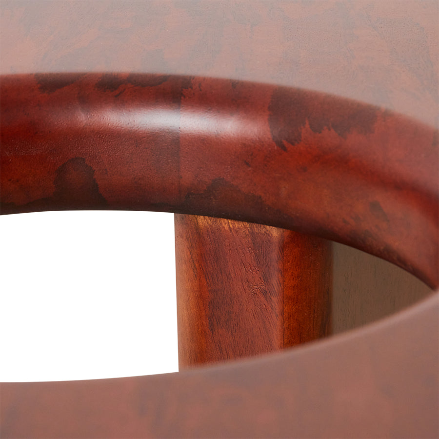 Close-up of a wooden table with a red-brown finish.