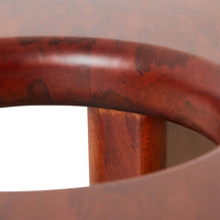 Close-up of a wooden table with a red-brown finish.