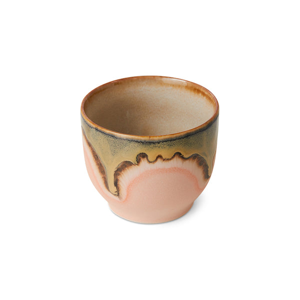 Ceramic cup with multicolored glaze on a white background