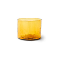 Yellow glass tumbler on a white background