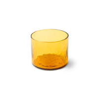 Amber glass tumbler on a white background