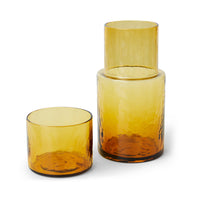Two amber glass tumblers on a white background