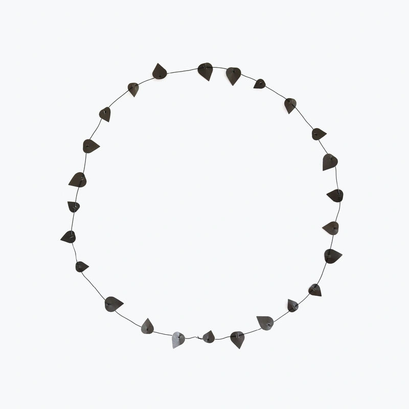 wreath with black paper leaves on a white back ground