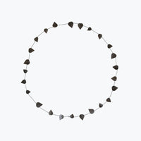 wreath with black paper leaves on a white back ground