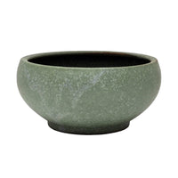 Green ceramic bowl on a white background