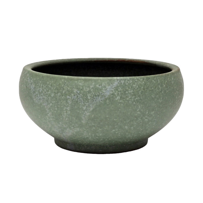 Green ceramic bowl on a white background