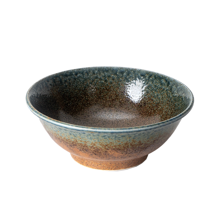 Ceramic bowl with speckled glaze on a white background