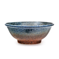 Ceramic bowl with blue and brown gradient on a white background