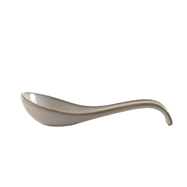 White ceramic spoon with beige rim on white background