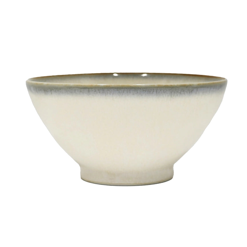 Beige ceramic bowl with a blue rim on a white background