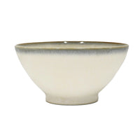 Beige ceramic bowl with a blue rim on a white background