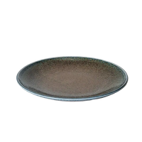 Ceramic plate with speckled design on a white surface