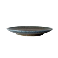 Ceramic plate with textured surface on a white surface