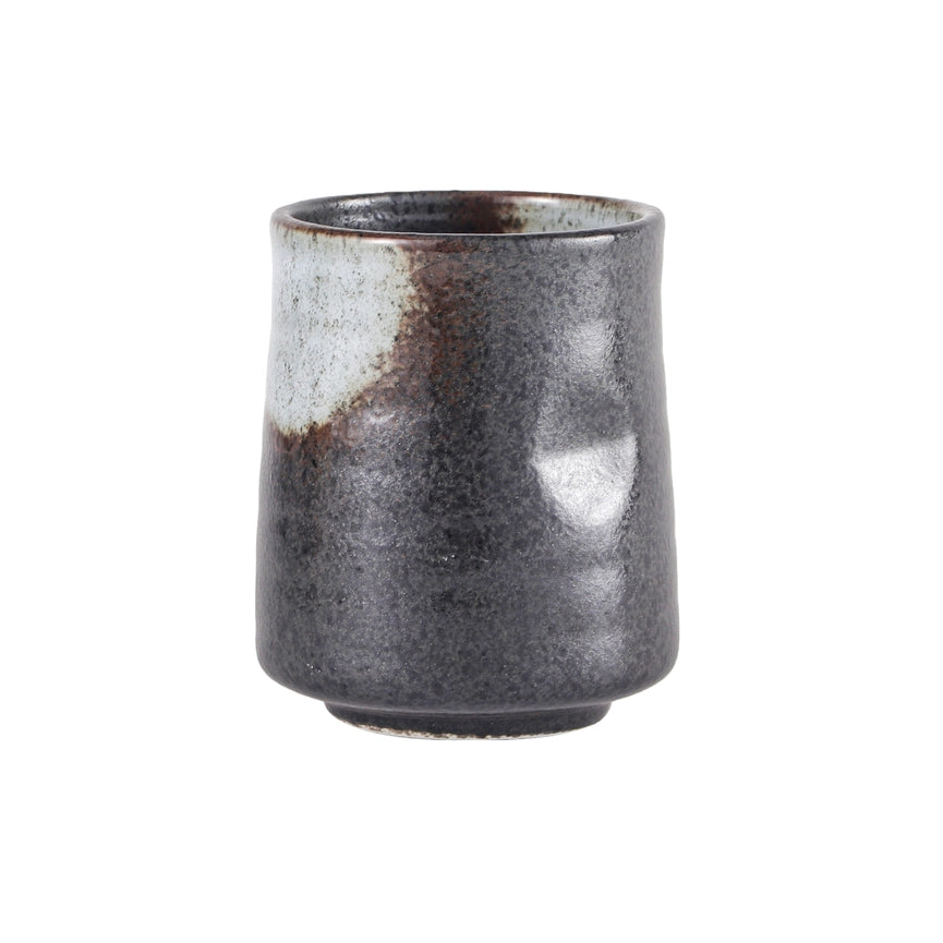 Stoneware cup with a textured surface on a white background