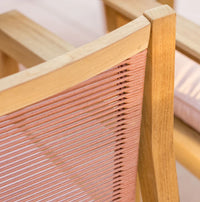Close-up of a wooden chair with woven seat