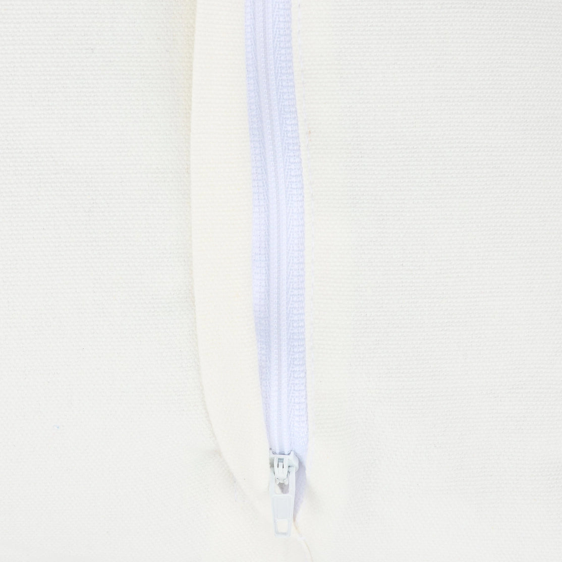 Close-up of a white zipper on a light beige background