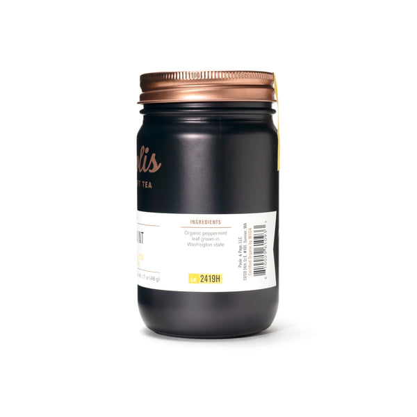 Black jar with a copper lid on a white background
