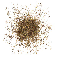 Dry tea and her leaves scattered on a white background