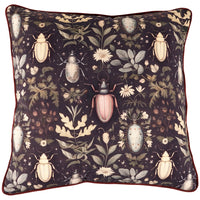 Decorative pillow with beetle and floral pattern on a dark background