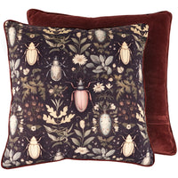 Decorative pillow with beetle and floral pattern on a dark background