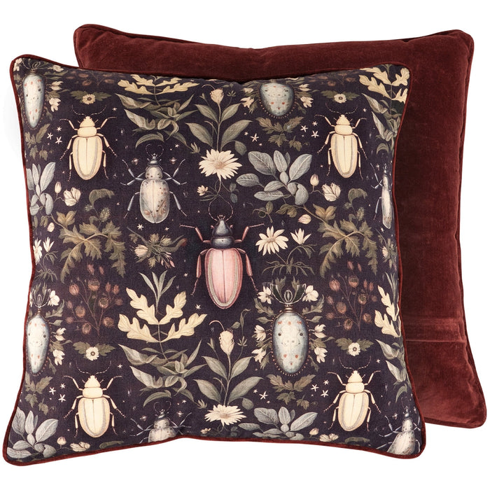 Decorative pillow with beetle and floral pattern on a dark background