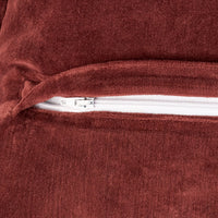 Close-up of a red velvet bag with a zipper