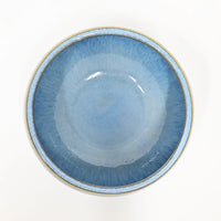 Blue ceramic plate on a white background