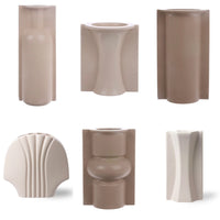 Set of various beige ceramic vases on a white background