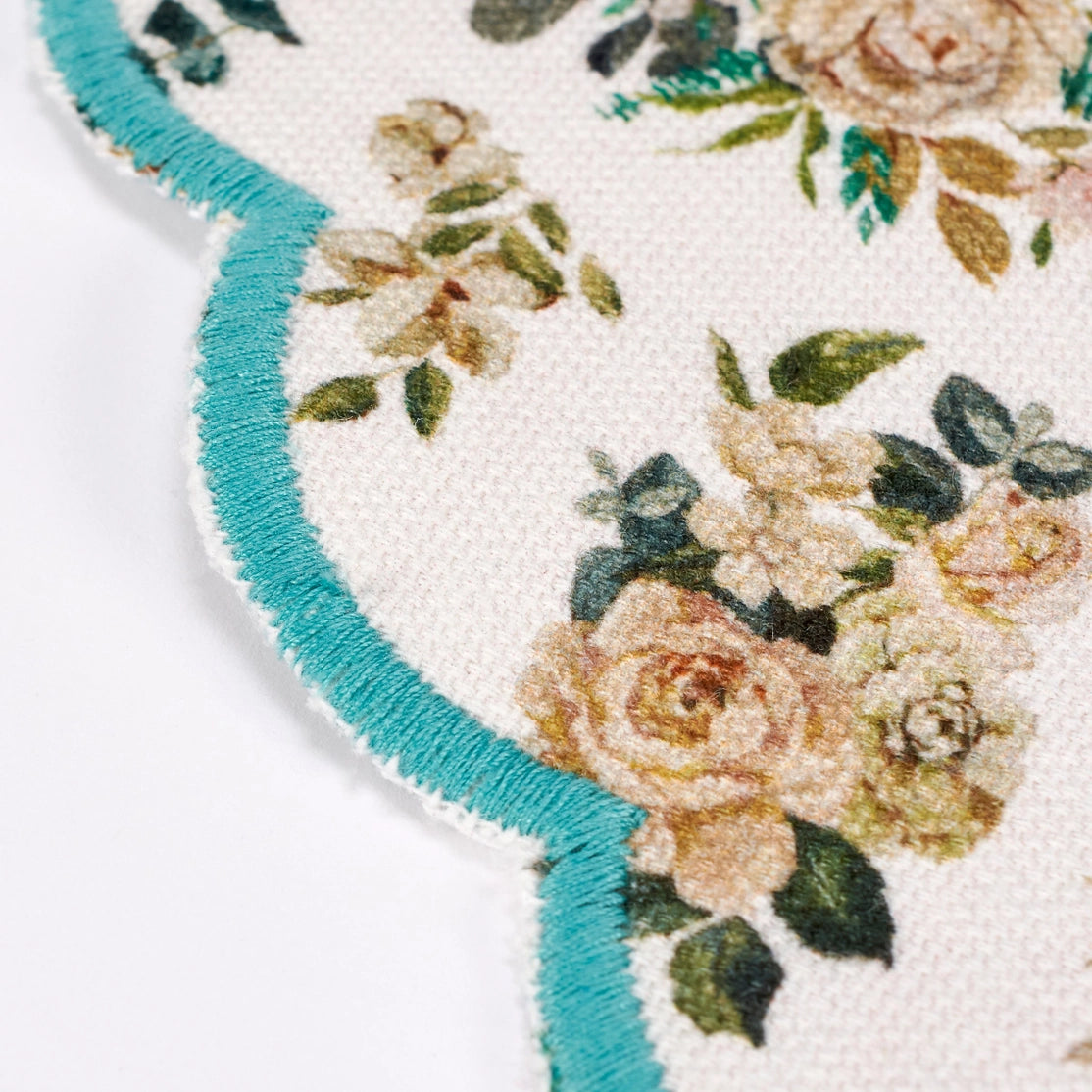 Floral patterned placemat with turquoise border on a white background