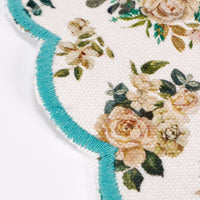 Floral patterned placemat with turquoise border on a white background