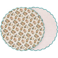 Round floral-patterned placemat with scalloped edge on a white background