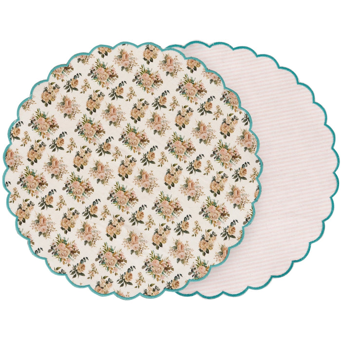 Round floral-patterned placemat with scalloped edge on a white background
