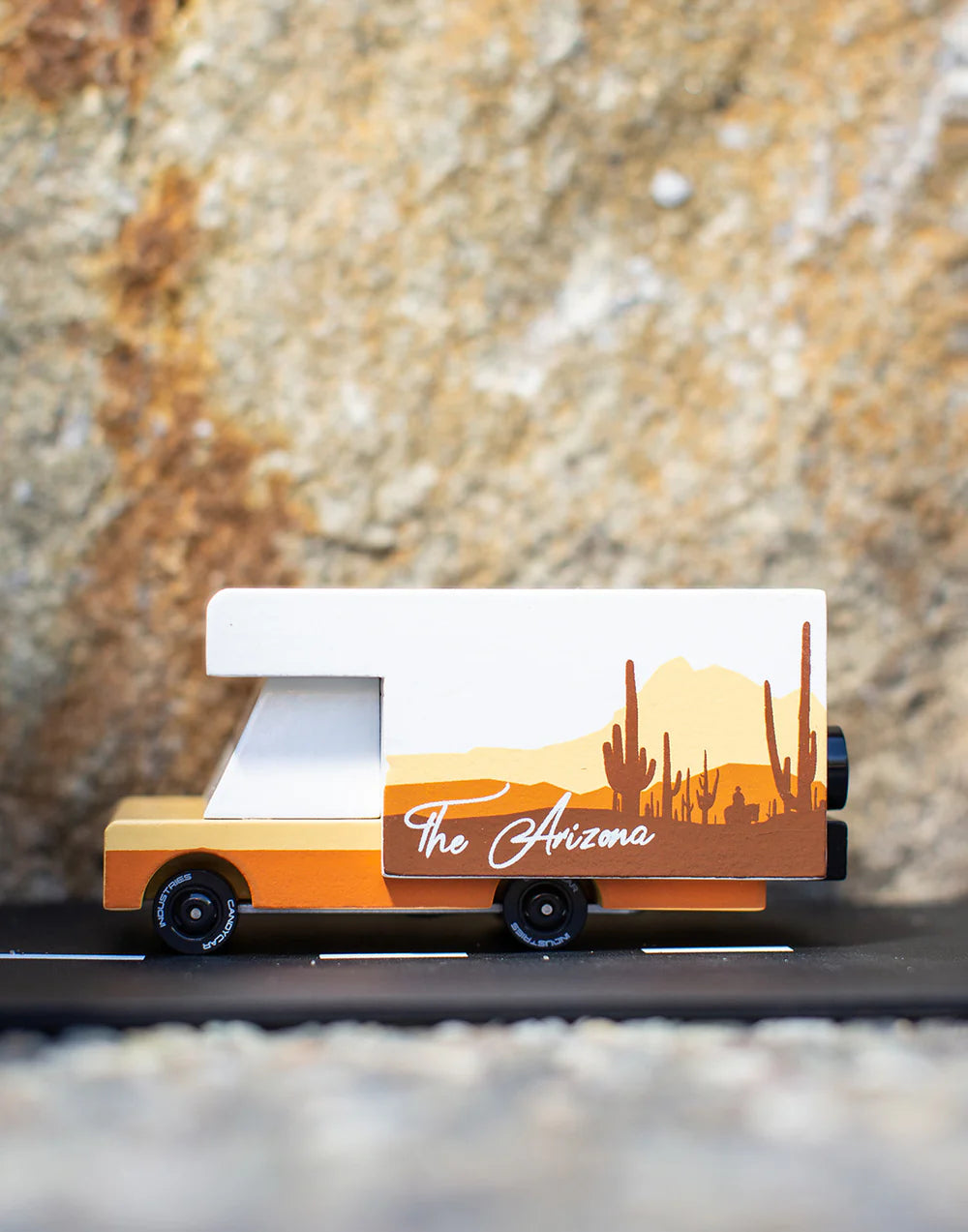 Model of a van with 'The Arizona' branding against a textured stone background