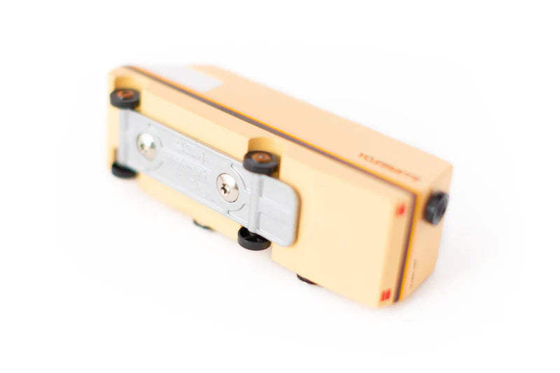 bottom of a wooden toy car RV Bus with metal and plastic chassis on white back ground 