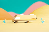 Toy van with 'Volkswagen' branding on a colorful desert background