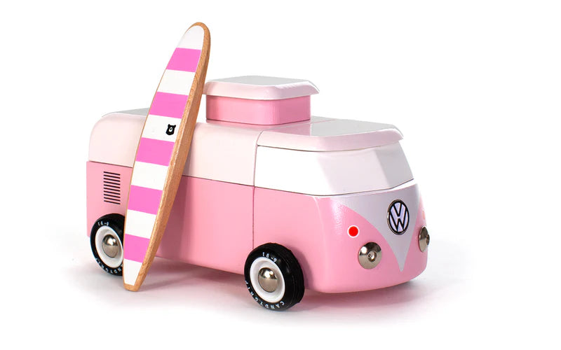 Pink Volkswagen camper van toy with a surfboard on a white background
