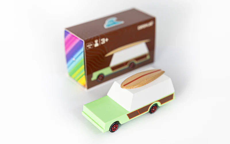 Small model of a camper van with a colorful box in the background