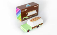Small model of a camper van with a colorful box in the background