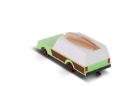Toy van with a surf board on a white background