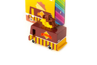Colorful toy truck with a character on top against a white background