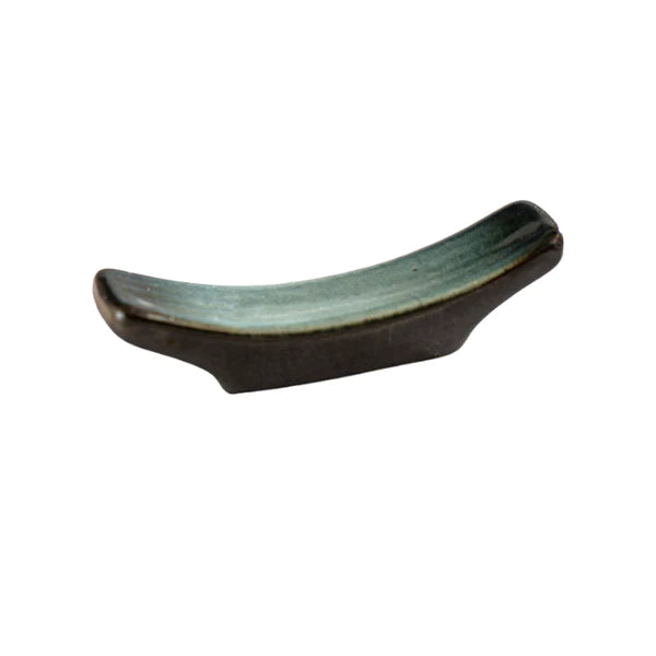 Ceramic dish with a curved design on a white background