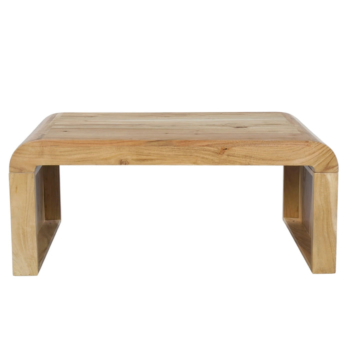 A low wooden table with a natural light oak finish, featuring a thick rectangular top with rounded corners and integrated block-style legs, shown against a plain white background.